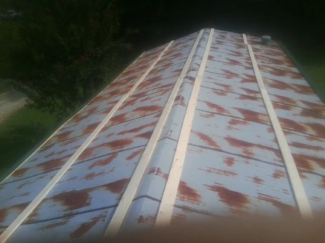 Rusted metal roof panels with new wood purlins before replacement — Storm Damage Roof Repair in Saint Helena Island by Roofing Brothers