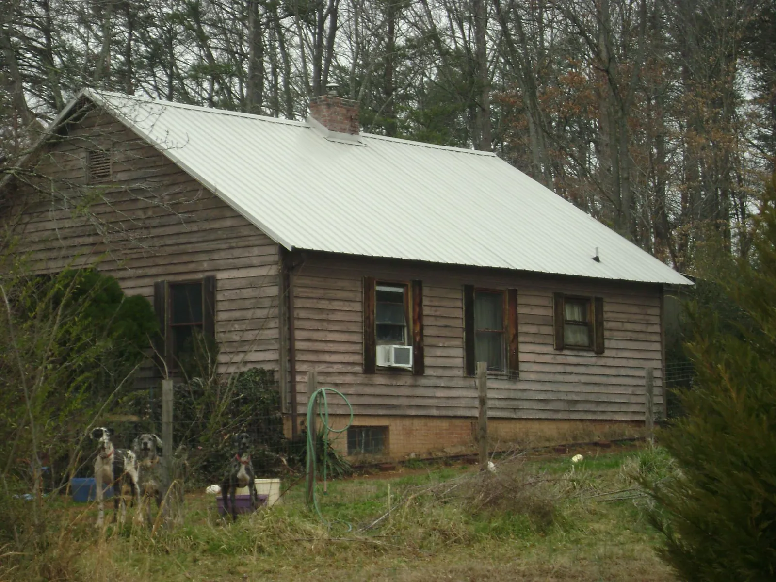 White metal roof on an old wood sided farmhouse, from a Asphalt Shingle Roof Repair job in Saint Helena Island